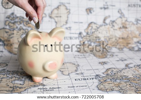 Saving money in piggy bank for travel and journey