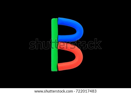 Colorful Alphabet " B " made from Plasticine (Clay) isolated on black background.
