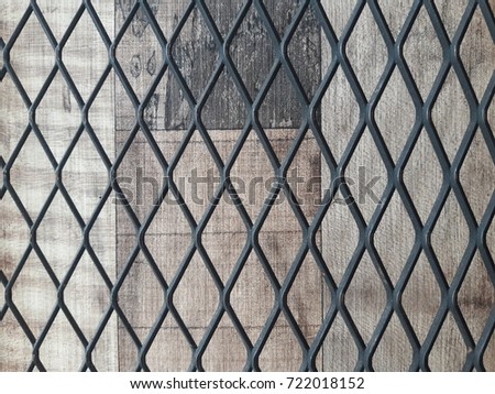 Aluminum mesh and wood brown background.