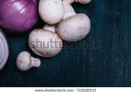 Mushrooms Champignon on dark wooden background