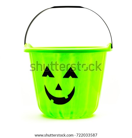 Studio shot Jack O' Lantern Halloween candy bucket isolated on white background. Green plastic Trick Or Treat candy pail.