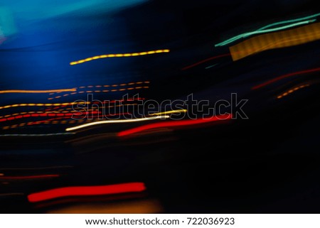 Abstract motion blur of multicolor night light on a black backgr