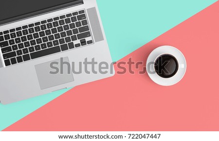 Modern workplace with coffee cup and laptop copy space on color table background. Top view. Flat lay style.