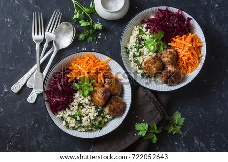 Fall buddha bowl. Bulgur, spinach, meatballs, beets, carrots - balanced healthy eating lunch. On a dark background, top view. Comfort autumn winter food  