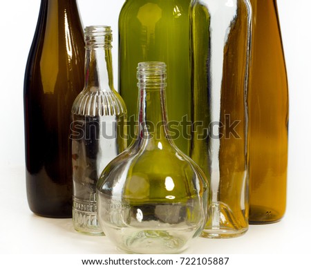 Background pattern, texture. Empty bottles of studio photography. Glass bottles of mixed colors, including green, transparent white, brown and blue. Group of bottles