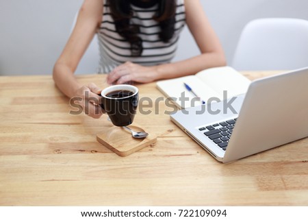 Business Young woman wearing smartwatch using laptop computer. Female working on laptop in cafe.  woman working concept