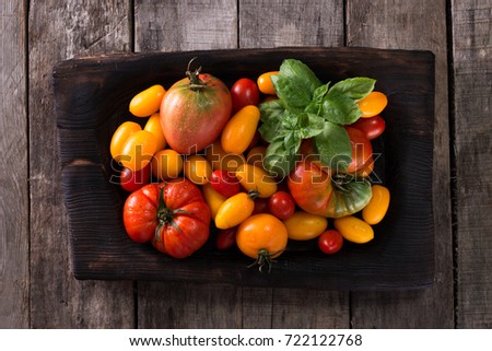 Colorful  red , yellow, orange , green,black tomatoes. autumn background. vintage wooden background