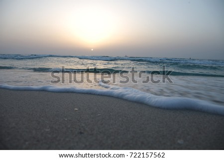 shore of the azure sea during sunset. sea waves on a sandy beach