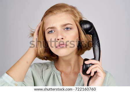 emotions on her face, the woman holding the phone to your ear, talking on landline phone, call                               