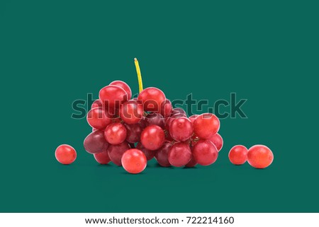 Ripe red grape isolated on green background. With clipping path.