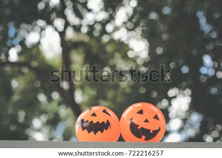 Self Made hand drown Smiley face Halloween Spooky balls in orange and yellow on the window with forest background