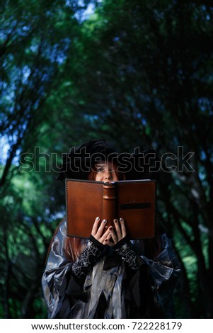 Photo of witches with large book