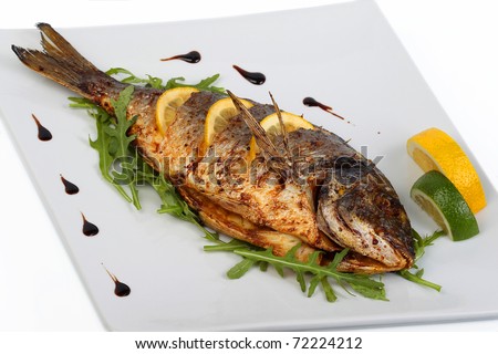 fried fish with fresh herbs and lemon Royalty-Free Stock Photo #72224212