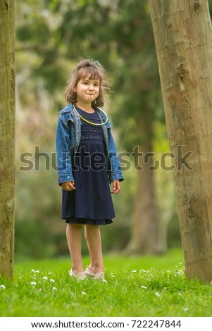 outdoor portrait of young happy girl having fun on playground