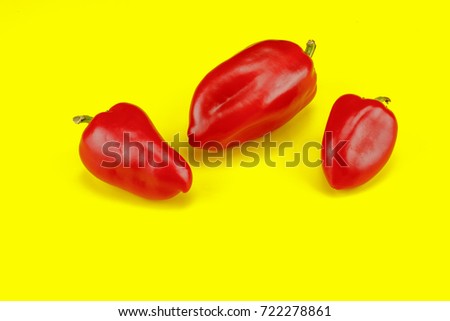 Red sweet pepper on yellow background