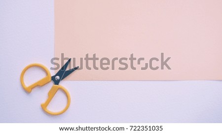 yellow scissor on paper.