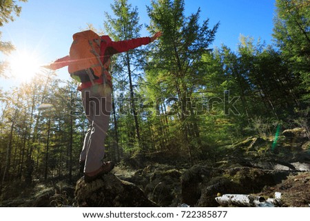 hiking woman enjoy the view in the sunrise autumn forest