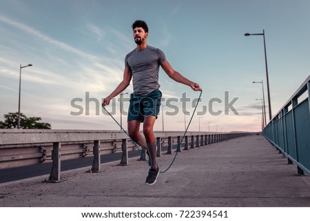 African american athlete man working out on a skipping rope. Royalty-Free Stock Photo #722394541