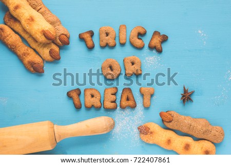 Halloween witch fingers cookies for kids, funny recipe for Halloween party. Homemade cookies in form of terrible human fingers decoration almond nail to treat kids at Halloween party