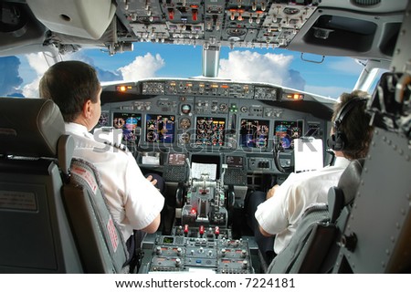 Pilots in the cockpit during a commercial flight Royalty-Free Stock Photo #7224181