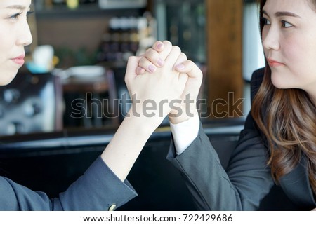 Businesswoman  engage in arm wrestling