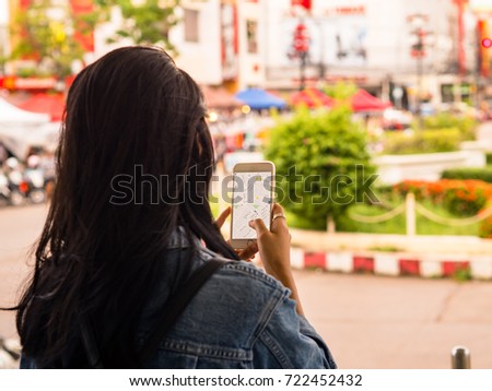 Asian Girl Traveler Looking on Her Phone to Get Direction on Her Holiday.
