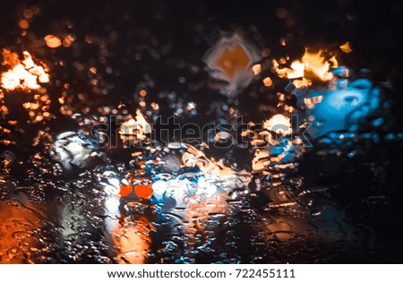 Magnificent city landscape in the side through the wet windshield of the car in the rain. Beautiful background