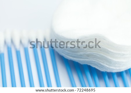 blue cleaning brush and cotton pads  isolated on white