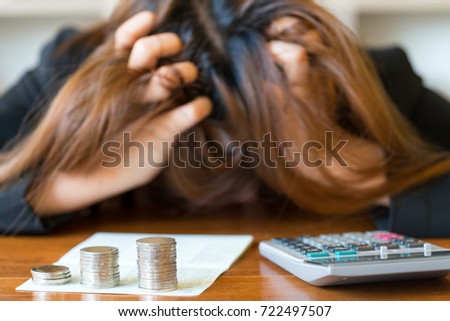 Stressed businesswoman running out of money - stock and market down Royalty-Free Stock Photo #722497507