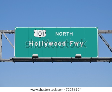 Hollywood 101 Freeway overhead sign with clear blue sky.