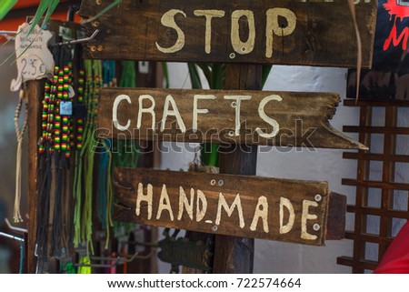 Wooden handmade vintage sign advertising souvenirs and trinkets in a beachside community. 