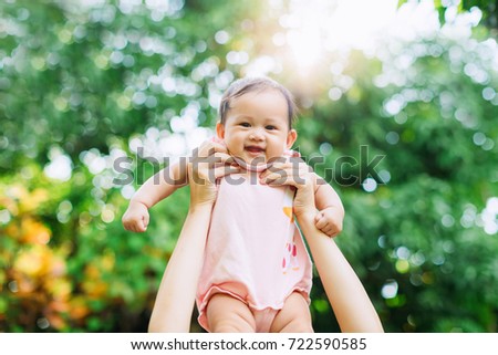 Family portrait of Asian people picture : 6 months baby feeling happy loving and smiles while playing with her mother.