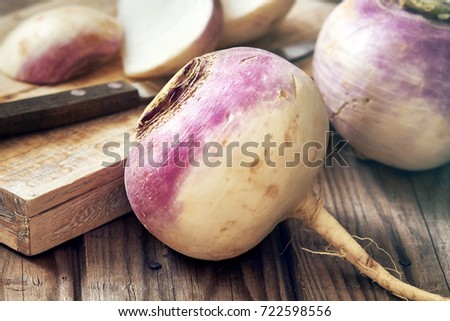 Closeup of raw organic turnips on rustic wooden background Royalty-Free Stock Photo #722598556