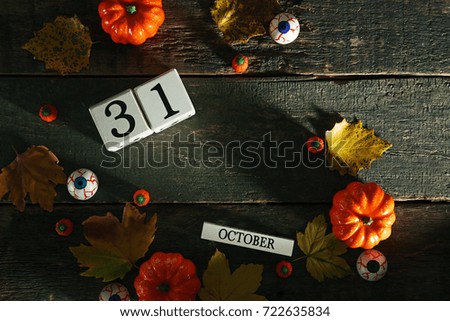 Halloween candies with pumpkins and wooden cube calendar
