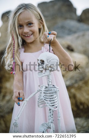  beautiful Little girl with  skeleton, halloween