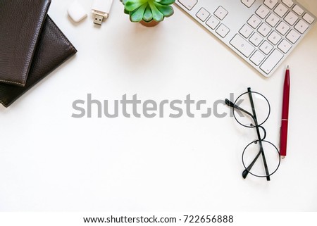 Modern white office desk table with laptop computer, Stylish tablet with black screen over. Minimal concept. Top view with copy space, flat lay. workspace creative designer