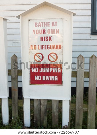 bathe at your own risk no lifeguard no jumping no diving warning sign; essex; england; UK