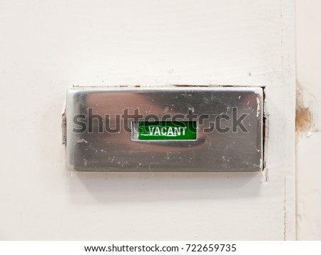 vacant door bathroom toilet sign metal white background; essex; england; UK