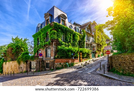 Cozy street of old Montmartre in Paris, France. Cozy cityscape of Paris. Architecture and landmarks of Paris.  Royalty-Free Stock Photo #722699386