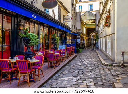 Typical view of the Parisian street with tables with tables of cafe in Paris, France. Architecture and landmark of Paris. Cozy Paris cityscape Royalty-Free Stock Photo #722699410