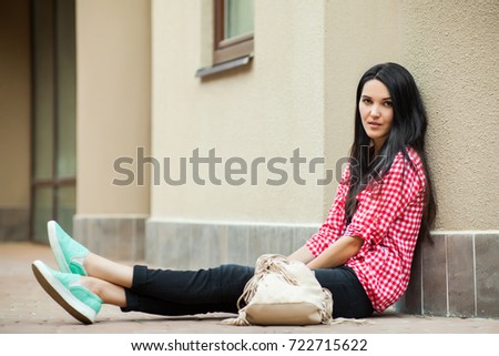 cute woman sitting on ground