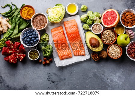 Healthy food clean eating selection: fish, fruit, vegetable, seeds, superfood, cereals, leaf vegetable on gray concrete background copy space Royalty-Free Stock Photo #722718079