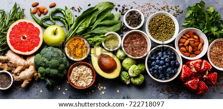 Healthy food clean eating selection: fruit, vegetable, seeds, superfood, cereal, leaf vegetable on gray concrete background Royalty-Free Stock Photo #722718097