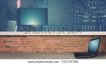 Network computer background present : laptop on the floor and business man working on tablet