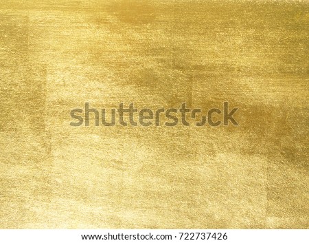 Shiny yellow leaf gold foil texture background Royalty-Free Stock Photo #722737426