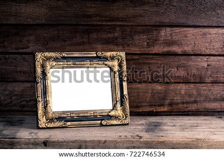 Old retro picture frame place on wooden table