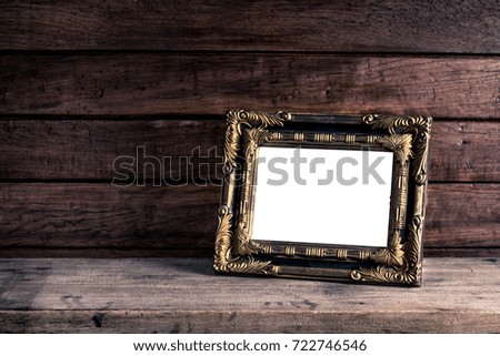 Old retro picture frame place on wooden table