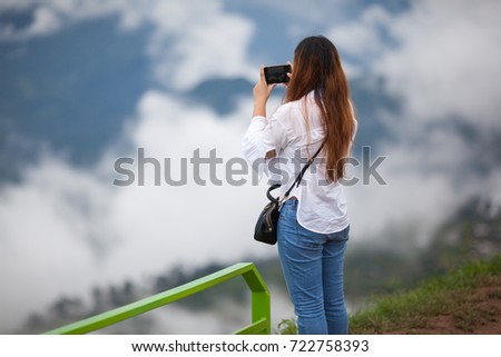 Girl with photography in the mountains and the sky