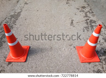 Traffic cone with on gray road, Equipment Increased traffic safety on the road, Orange traffic symbol with copyspace for your text
