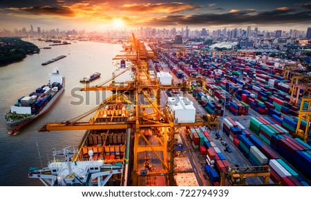 Logistics and transportation of Container Cargo ship and Cargo plane with working crane bridge in shipyard at sunrise, logistic import export and transport industry background Royalty-Free Stock Photo #722794939